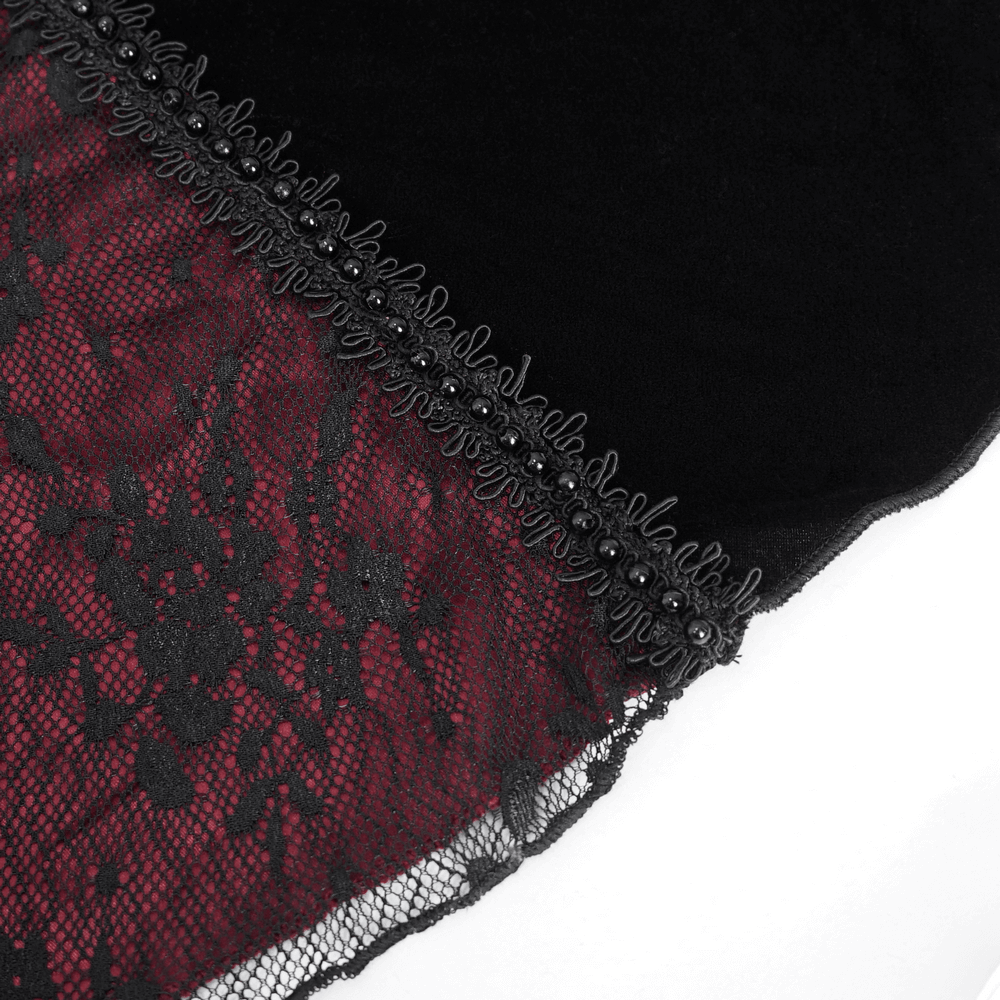 Close-up of burgundy floral lace appliques on black velvet fabric for gothic mermaid dress elegance.