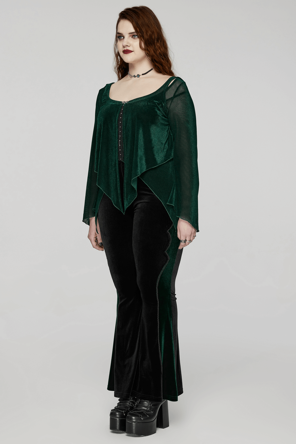 Chic women's green translucent top with bell sleeves and hooks, paired with stylish black flared pants.