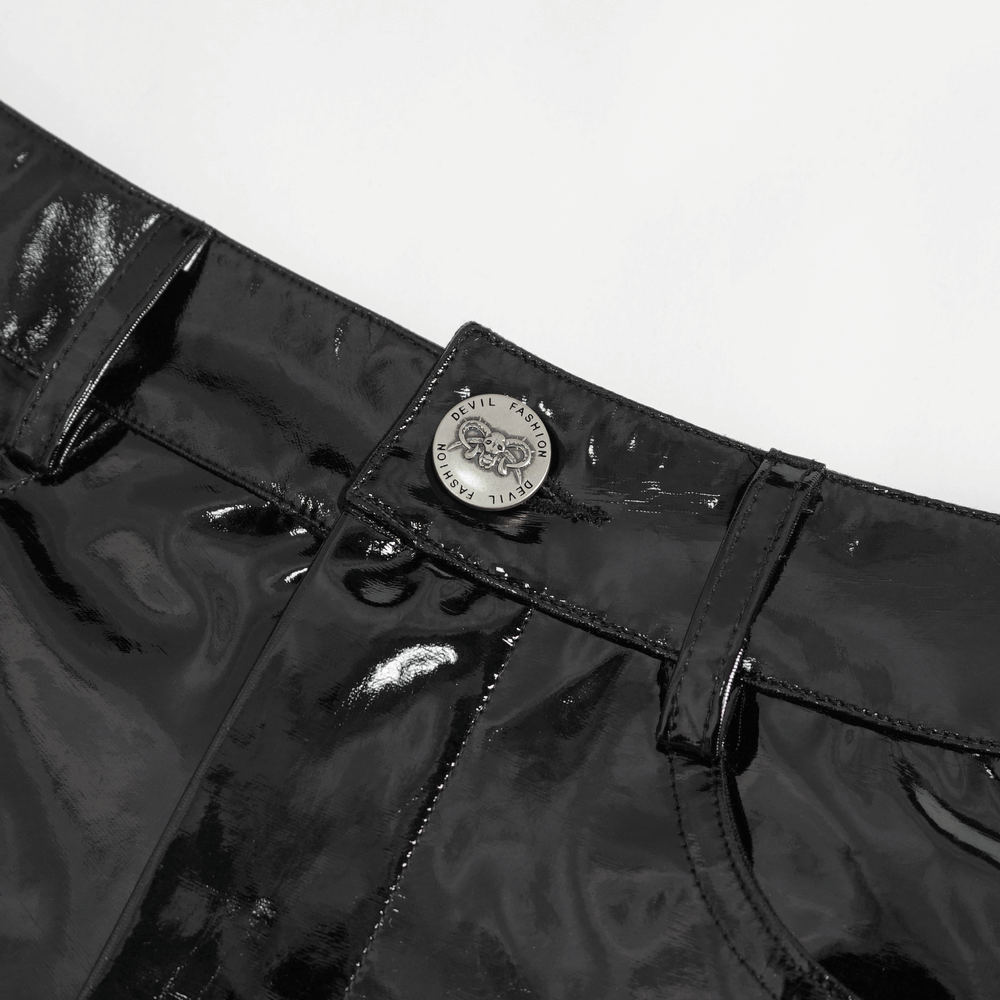 Close-up of women's high-waisted black faux leather shorts showcasing buckle detail and shiny finish.