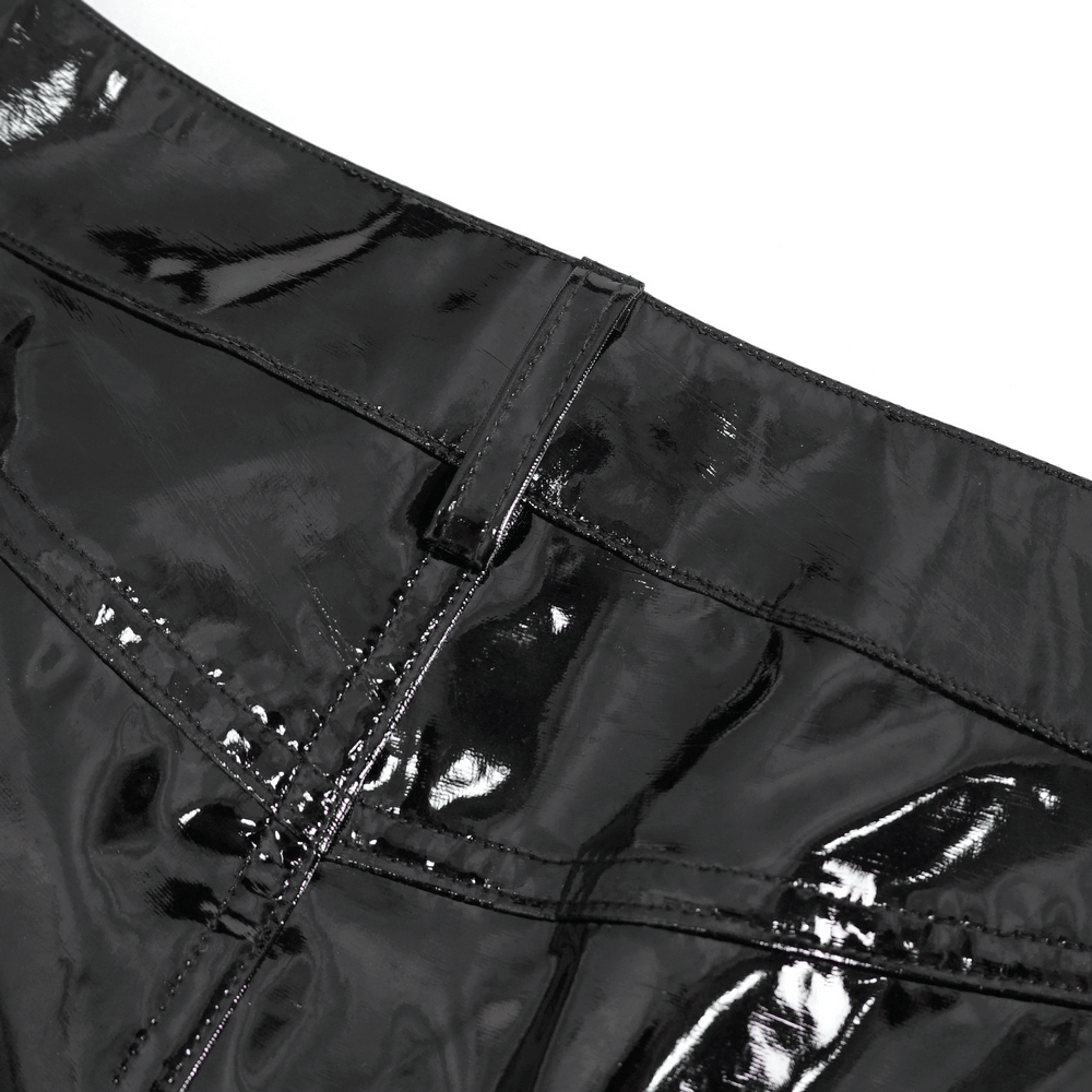 Close-up of high-waisted faux leather shorts, showcasing shiny black fabric and buckle detail for a stylish look.