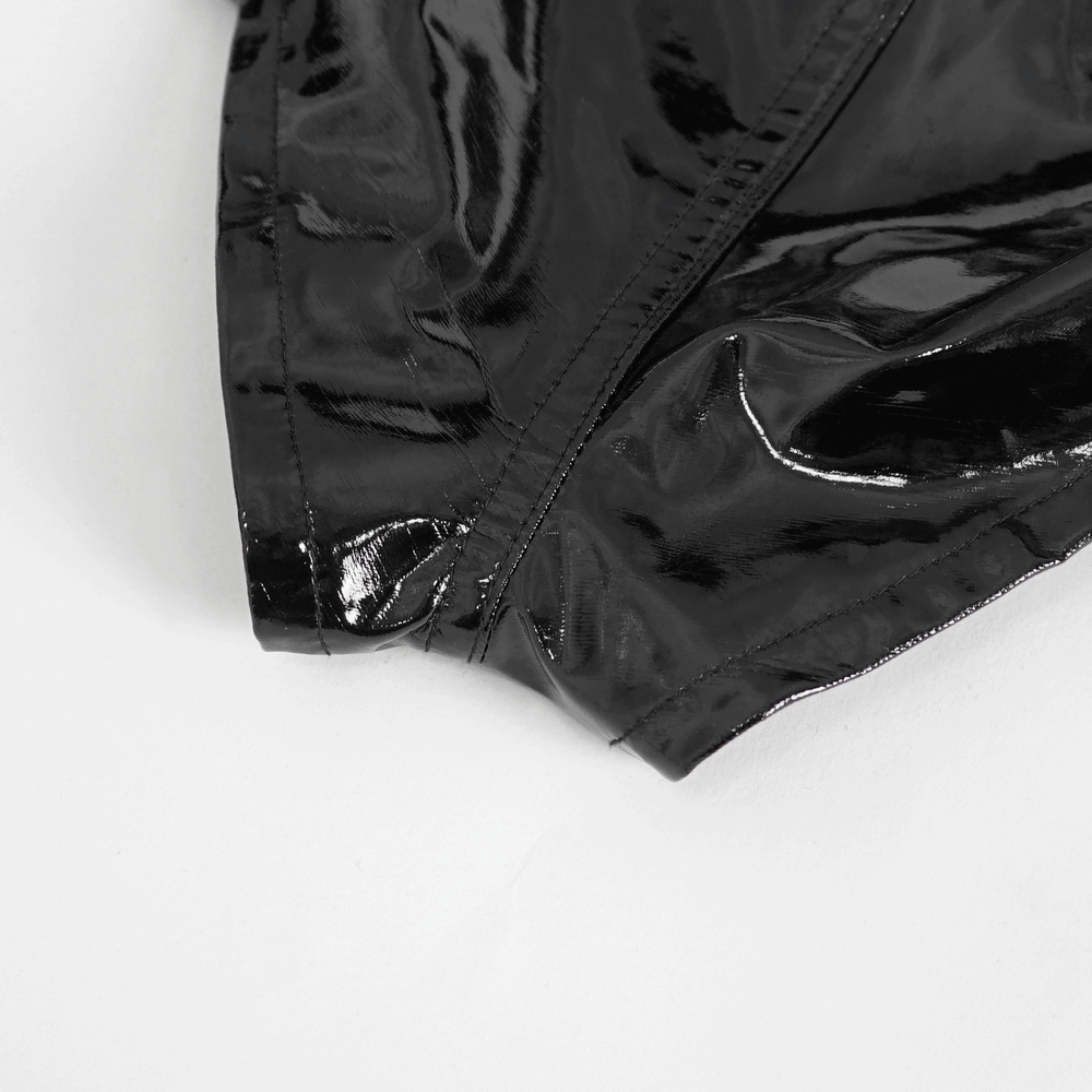Close-up of high-waisted black faux leather shorts showcasing glossy material and seam detailing.