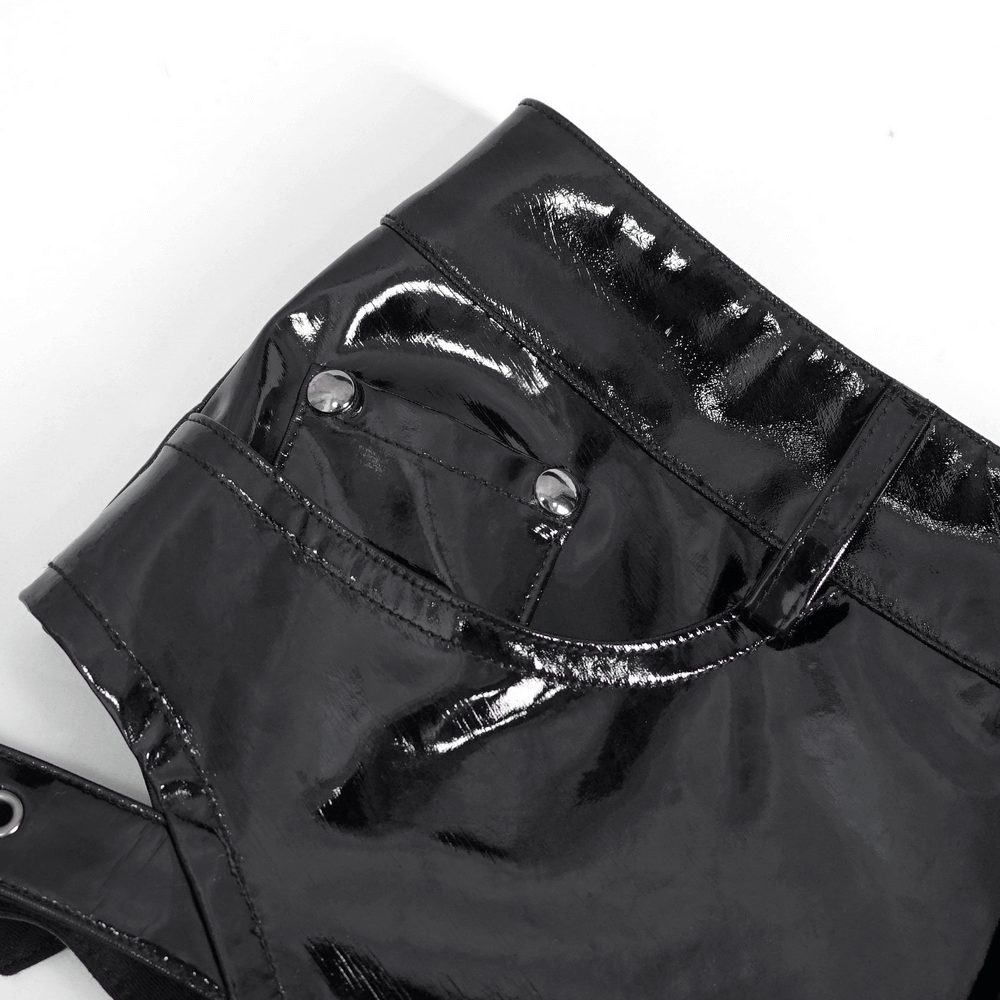 Close-up of women's high-waisted black faux leather shorts showcasing shiny texture and buckle details.