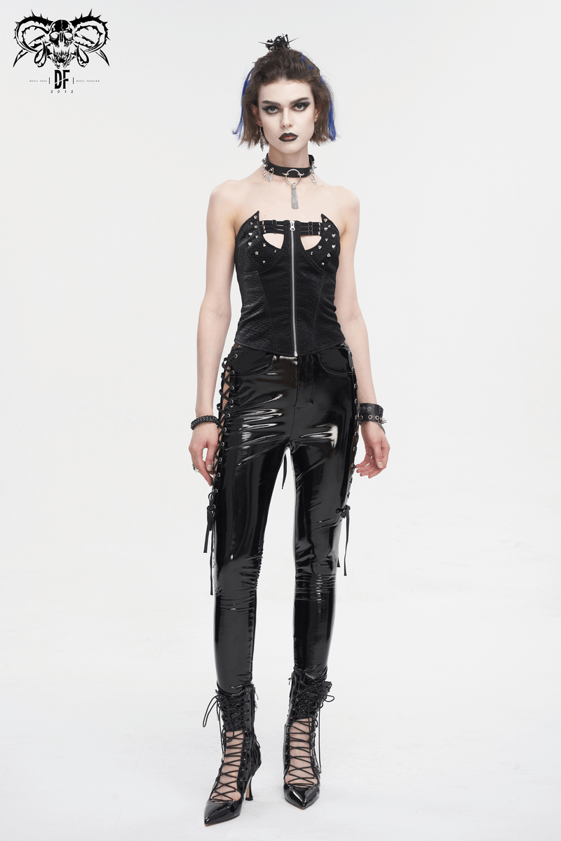 Women's edgy hollow patent leather skinny pants with lace-up sides, styled with punk chic accessories.