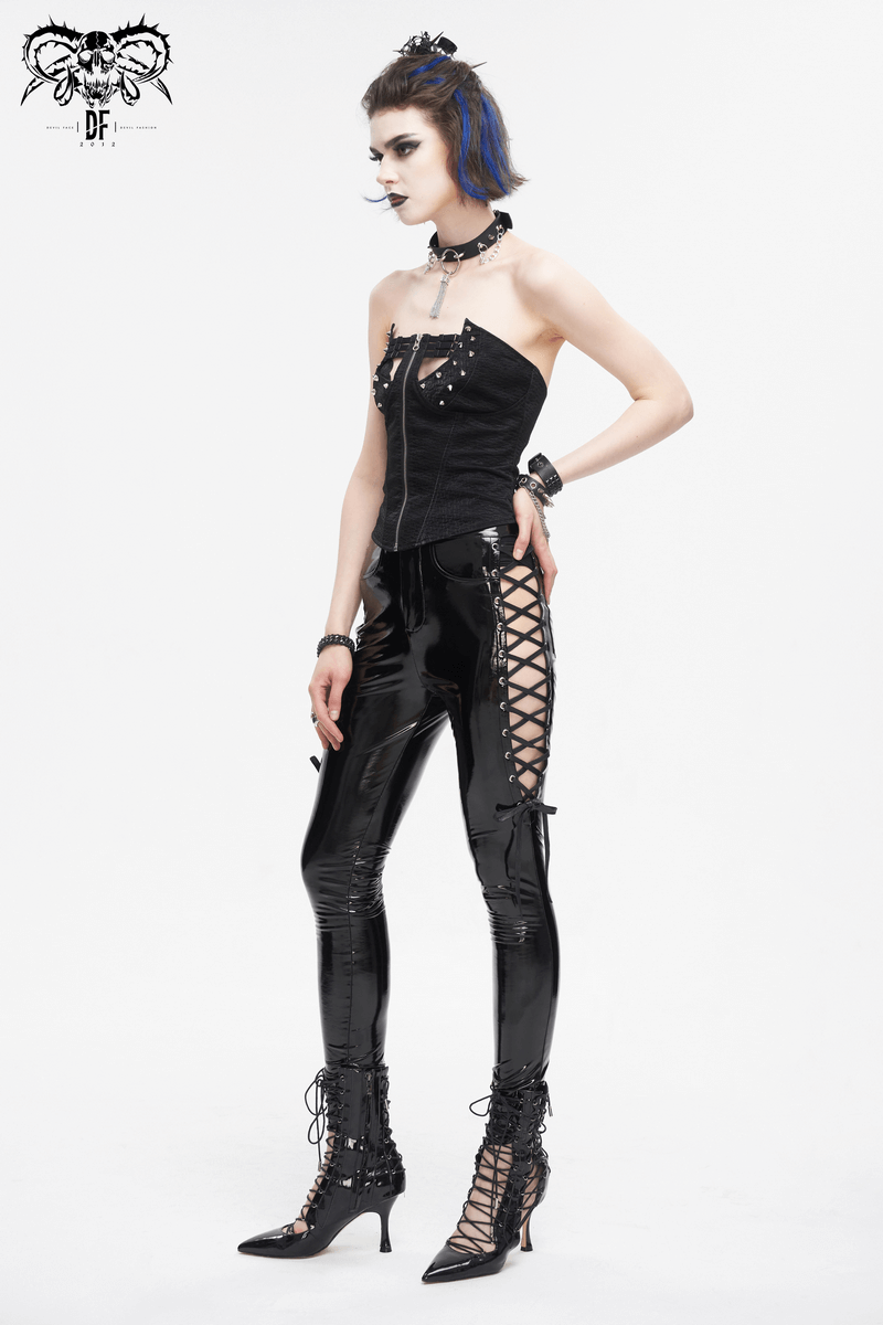 Edgy women's hollow patent leather skinny pants with lace-up sides, styled for a bold fashion statement.