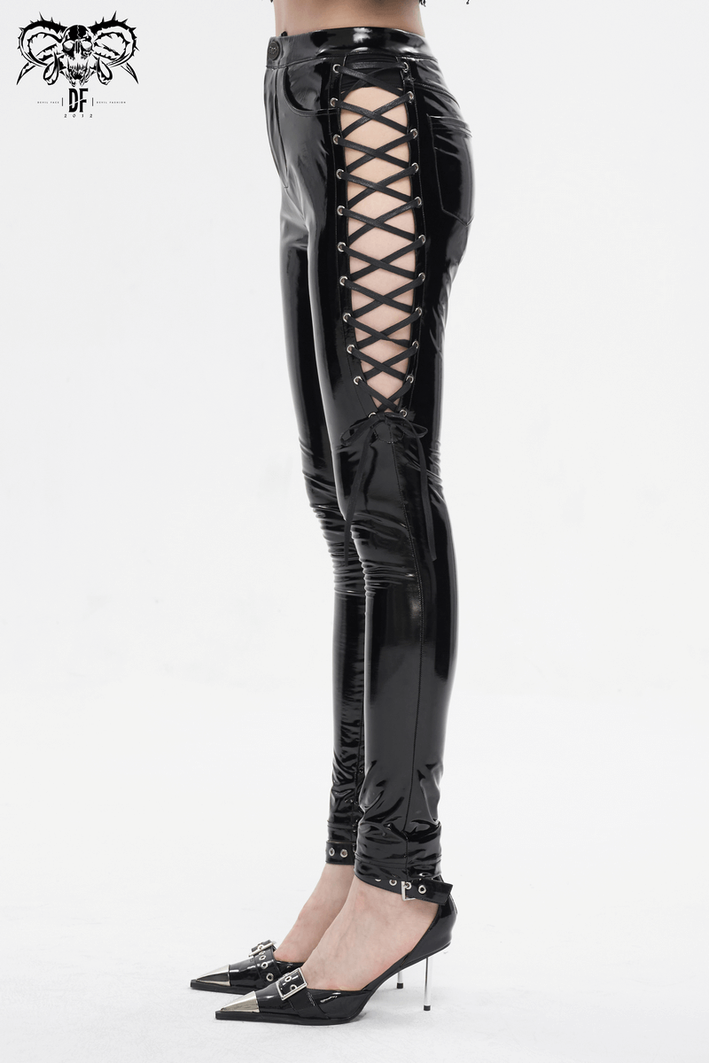 Women's black patent leather skinny pants with lace-up sides, showcasing edgy alternative fashion style.