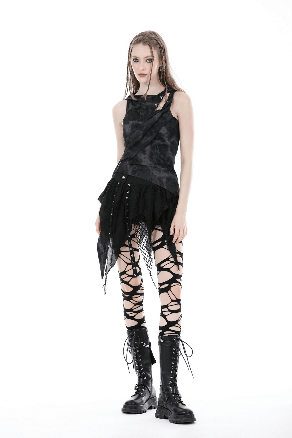 Gothic punk style: sleeveless top with dramatic skirt and ripped leggings for edgy fashion enthusiasts.