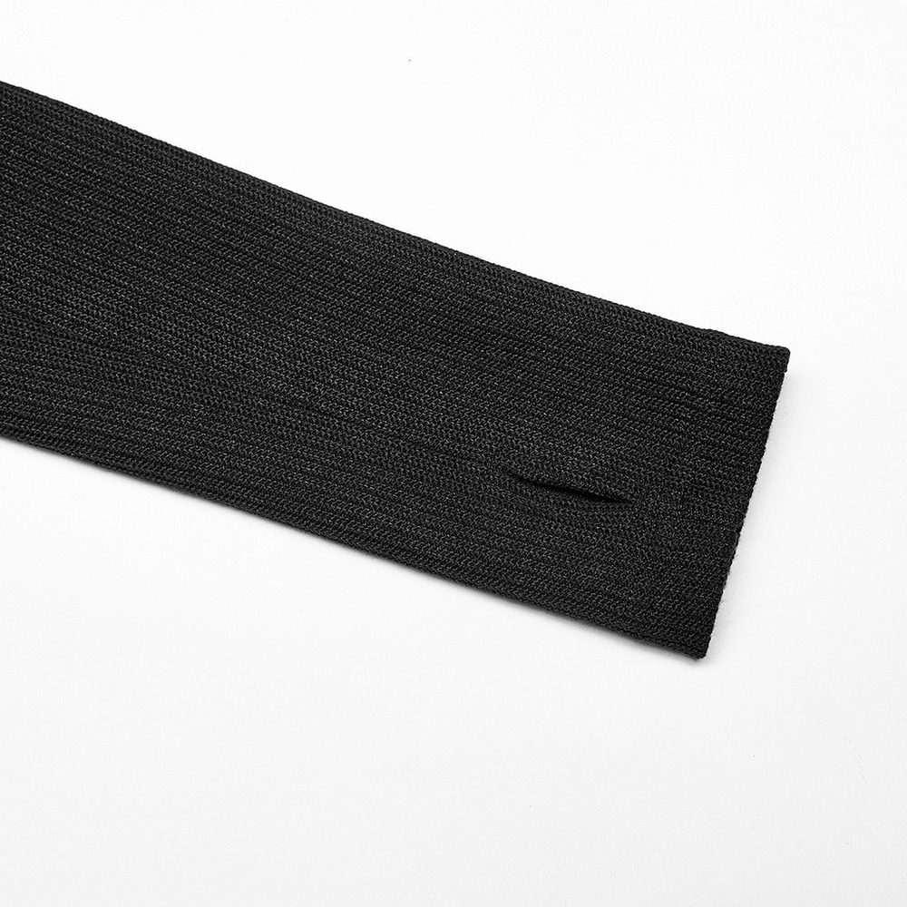 Close-up of the sleeve of a black knitted top, featuring a sleek slit for added style and comfort.