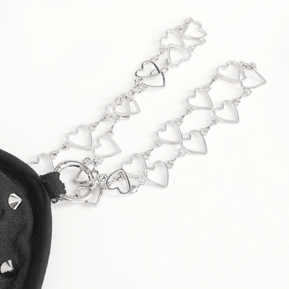 Silver heart chain strap detail on a black bag, adding a stylish and edgy touch.