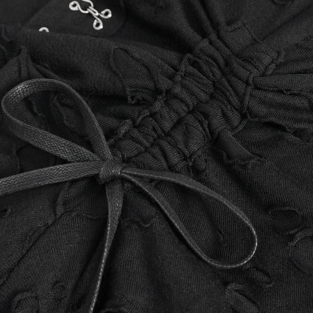 Close-up of black lace fabric with a drawstring detail for a chic evening look.