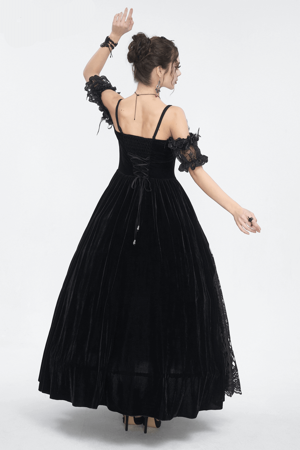 Elegant black lace evening dress with feathered short sleeves, showcasing a flowing skirt from the back.
