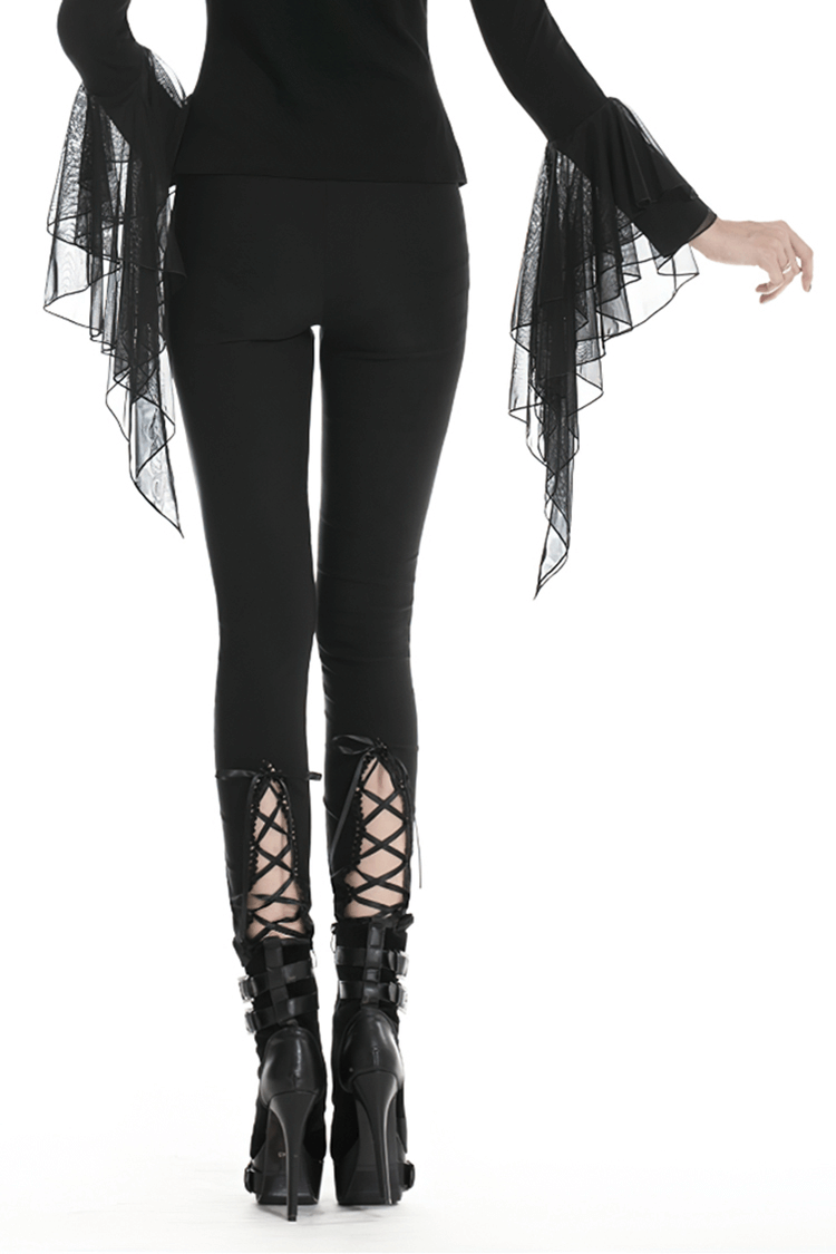 Elegant women's black leggings with lace-up flared cuffs and lace detailing, styled with a chic top.