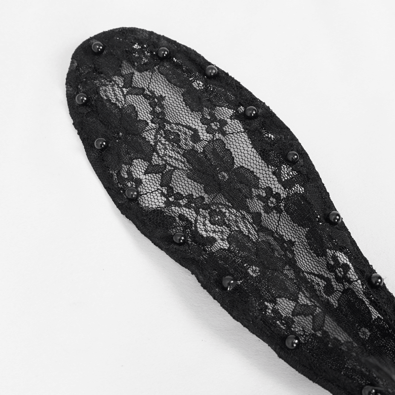 Close-up of a black lace rabbit ears headdress, embellished with beads, perfect for gothic style looks.