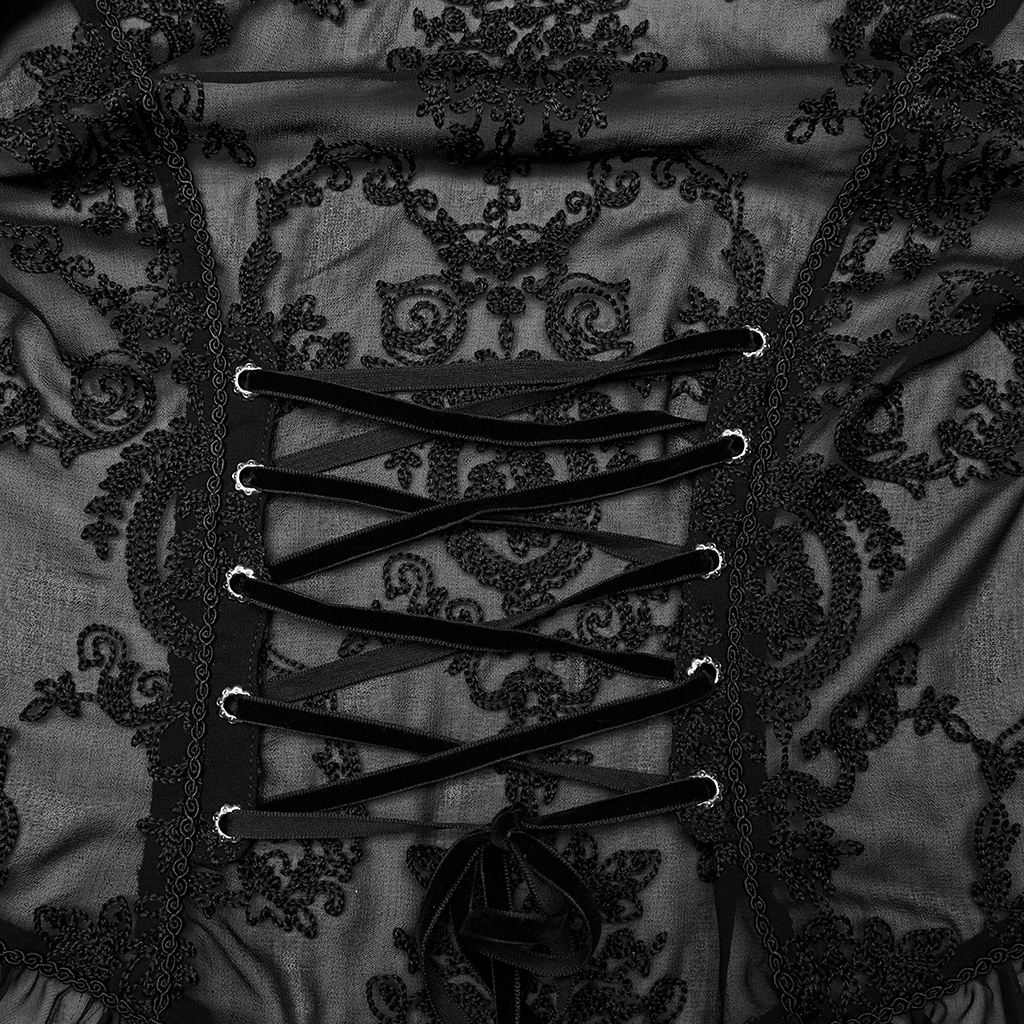 Close-up of gothic lace ruffle blouse detailing with embroidered patterns and velvet lacing for a dramatic evening look.