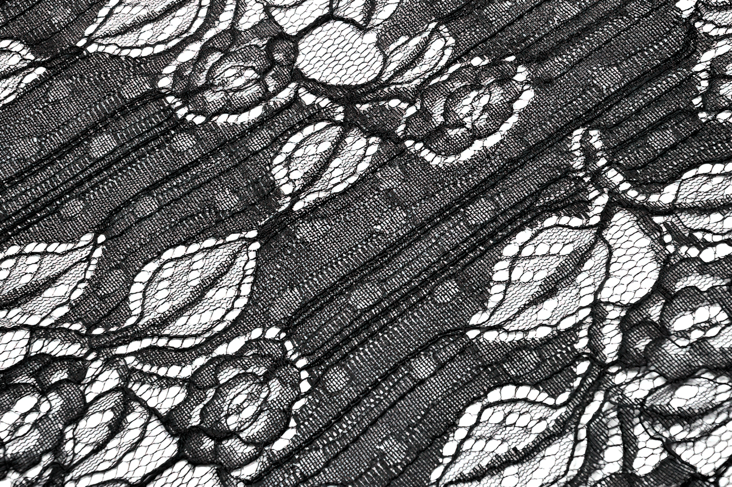 Close-up of intricate black lace fabric featuring floral patterns and delicate detailing.