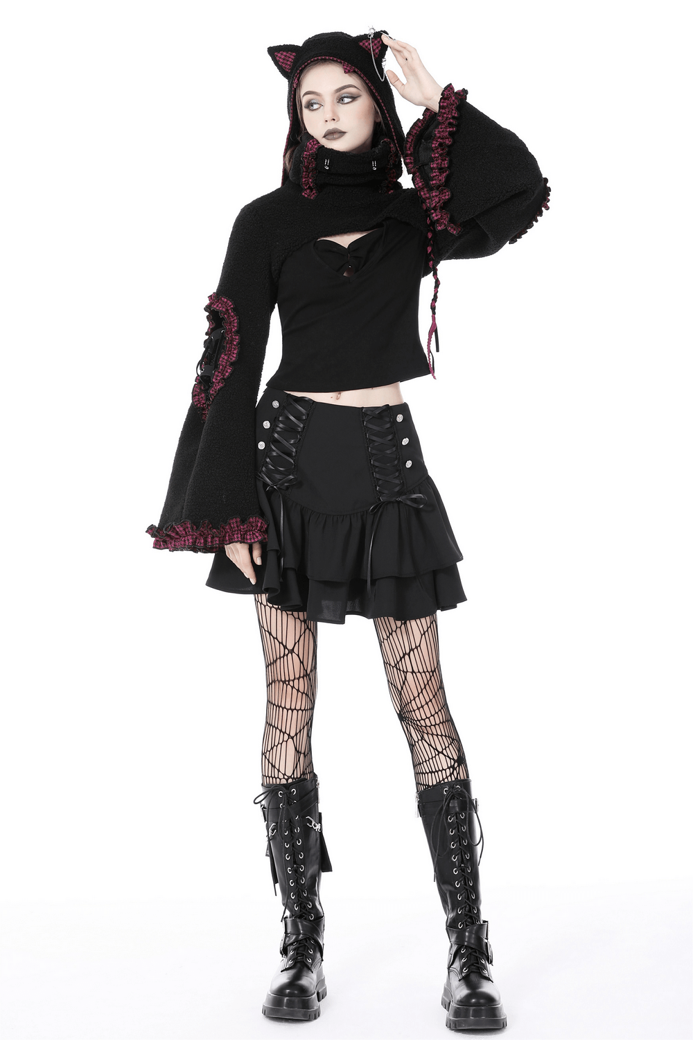 Model wearing a dark goth ruffled mini skirt with lace-up details and a matching cat hoodie, exuding alternative fashion vibes.