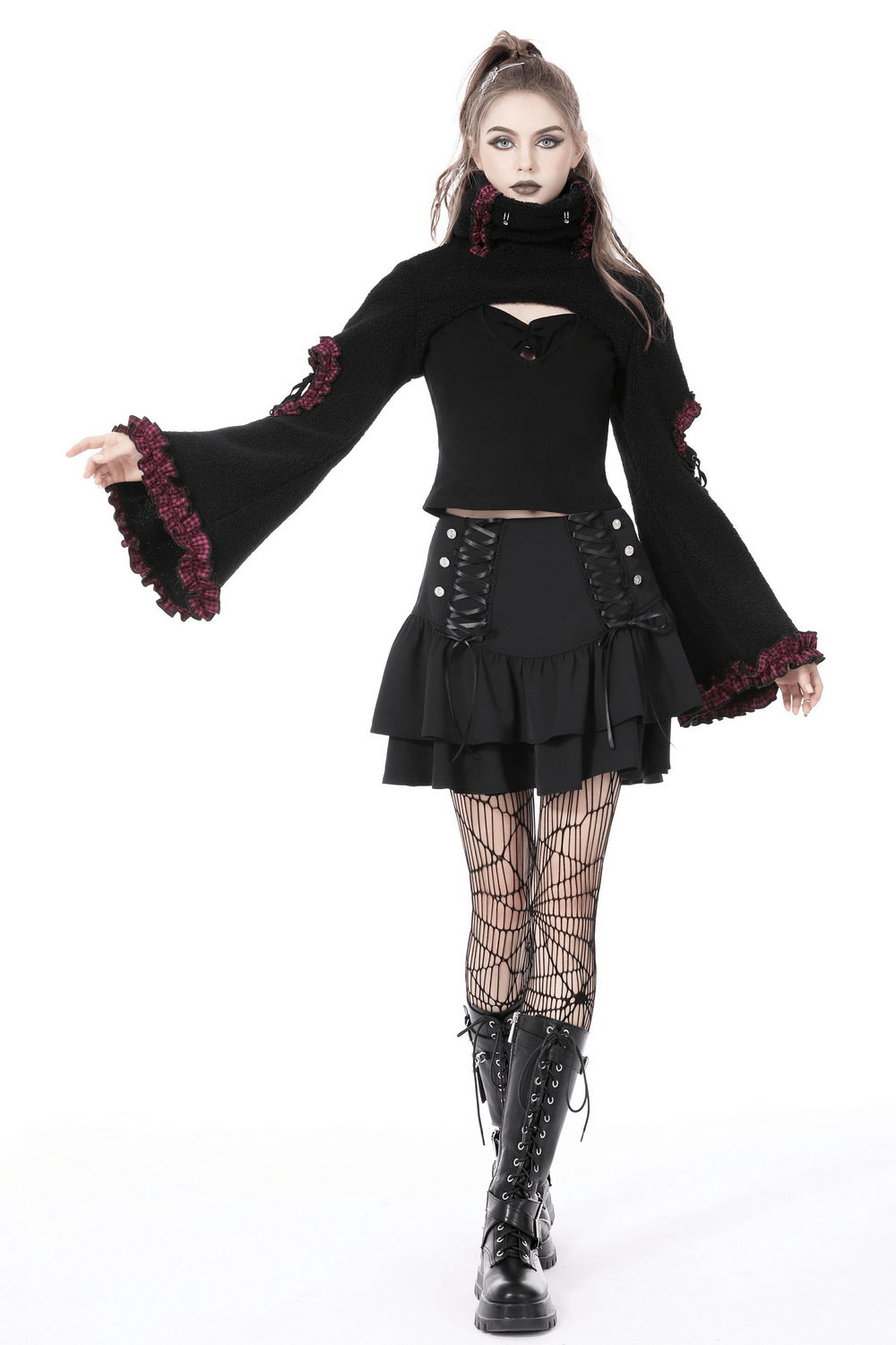Model in dark goth outfit with layered mini skirt and lace-up details, showcasing edgy style and feminine flair.