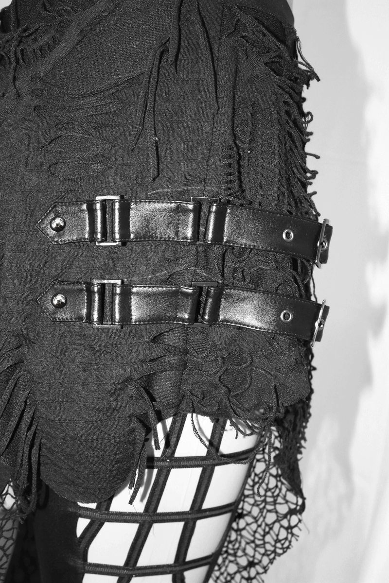 Close-up of black Gothic leggings with layered asymmetrical skirt and decorative straps, showcasing unique torn detailing.