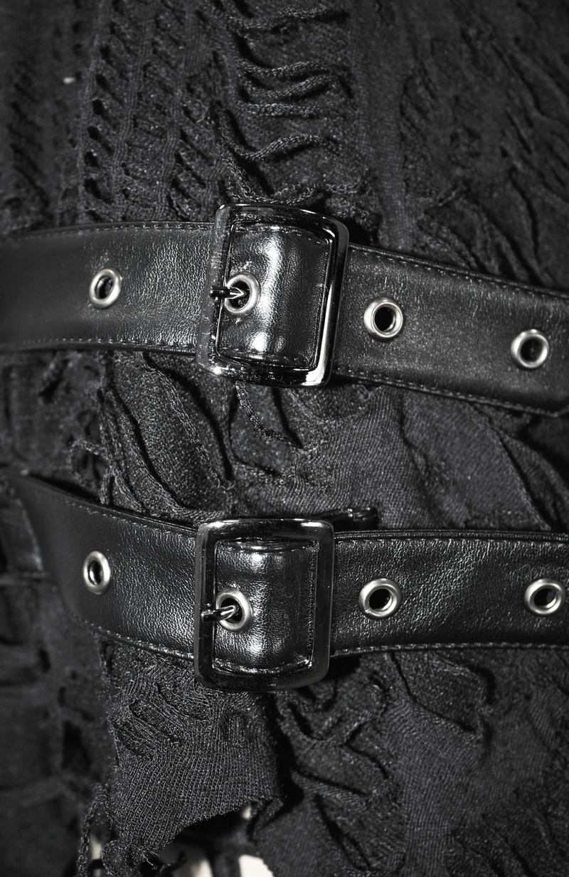 Close-up of black belts with buckles on torn fabric, showcasing gothic fashion details.