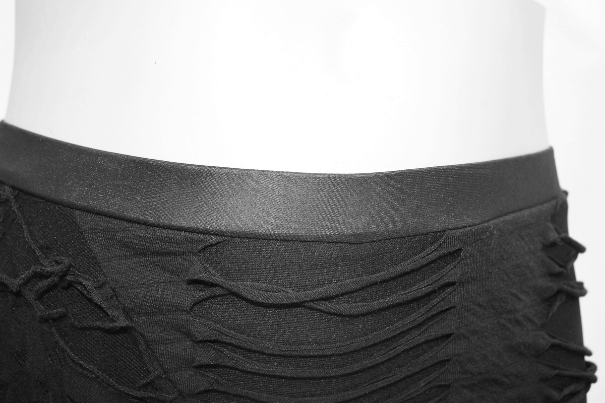 Close-up of women's black gothic leggings featuring a torn design and sleek waistband for a stylish look.