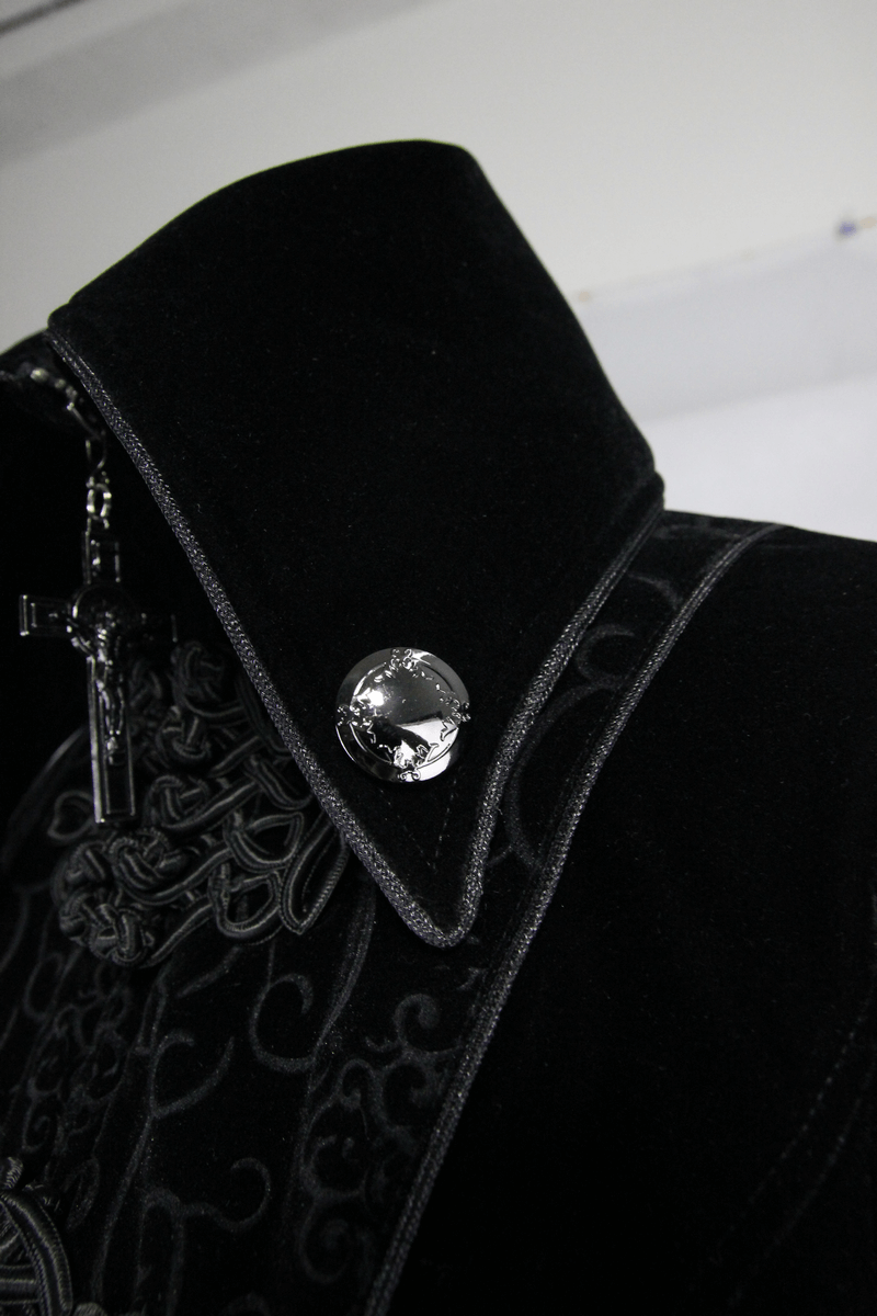 Close-up of the stand-collar and intricate design of a women's black gothic coat.