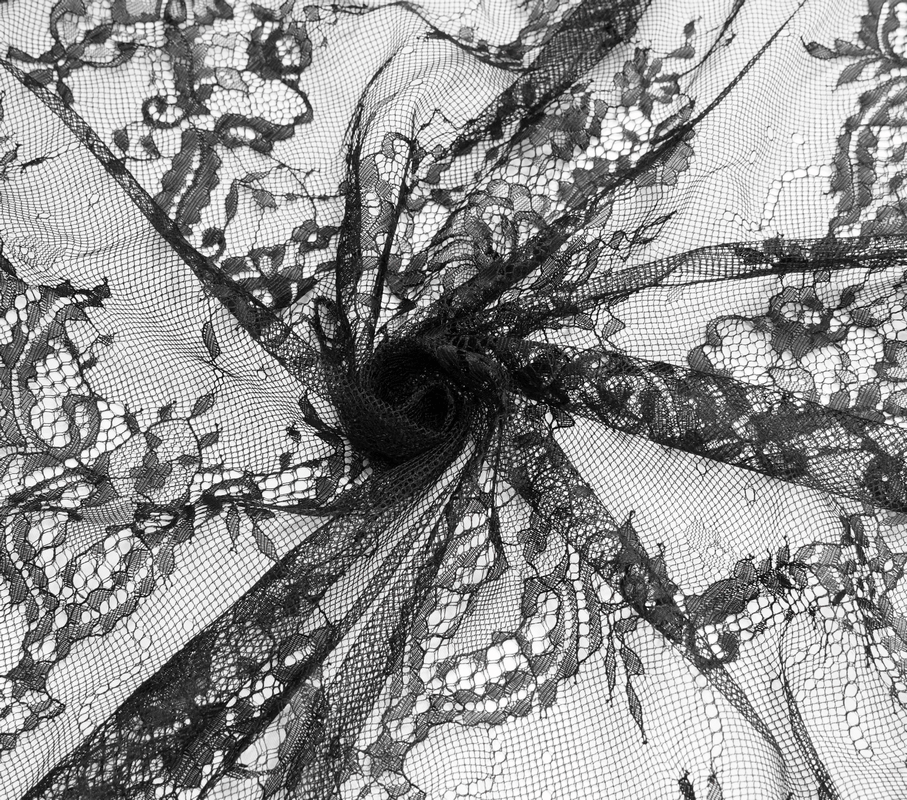 Delicate black lace fabric showcasing intricate floral patterns, perfect for gothic style fashion designs.