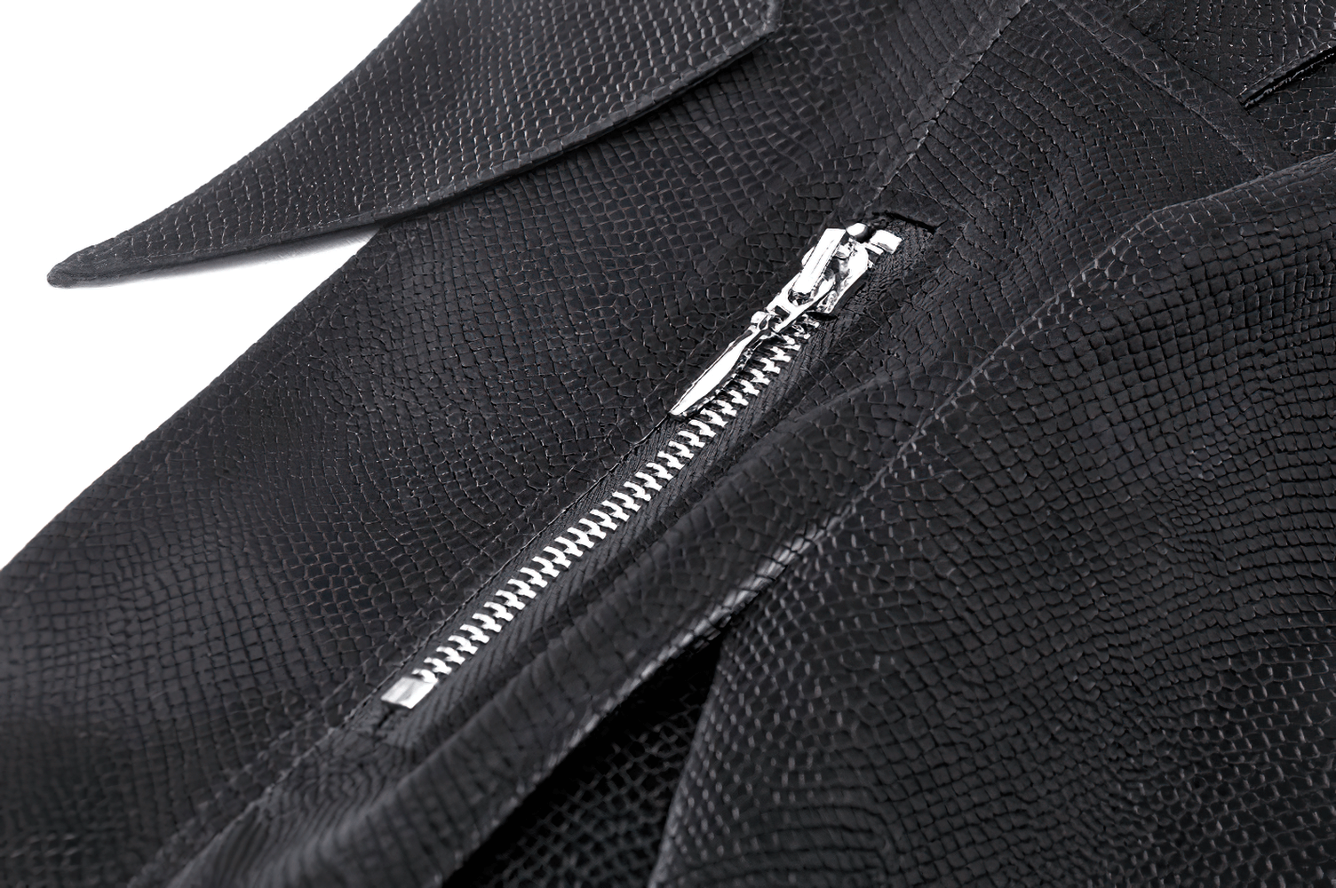 Close-up of sleek black fabric with a zipper detail, showcasing elegant texture and style for a gothic-inspired cape.