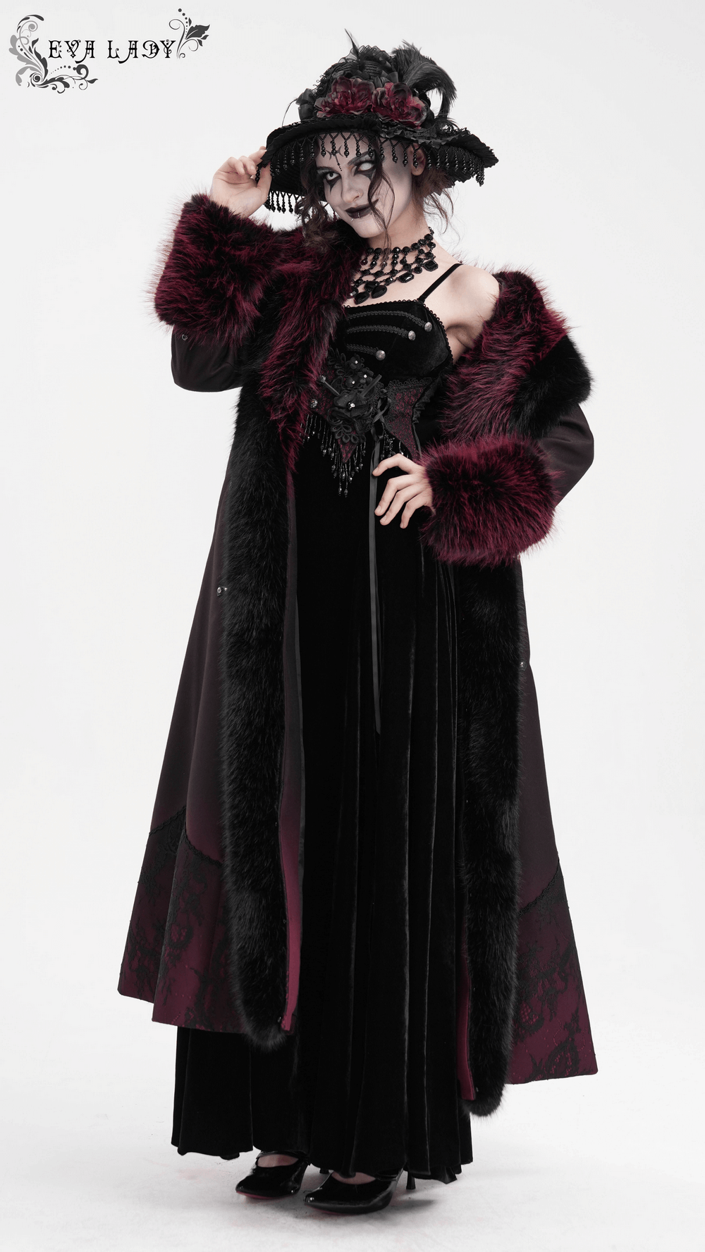 Gothic-inspired women's long coat with dark faux fur trim and silver cross buckles, ideal for a stylish winter wardrobe.