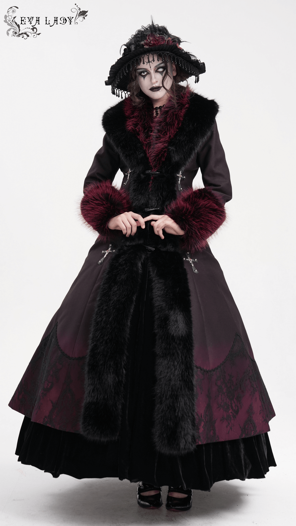 Women's gothic long coat with faux fur trim, silver cross buckles, and A-line silhouette, perfect for winter fashion.