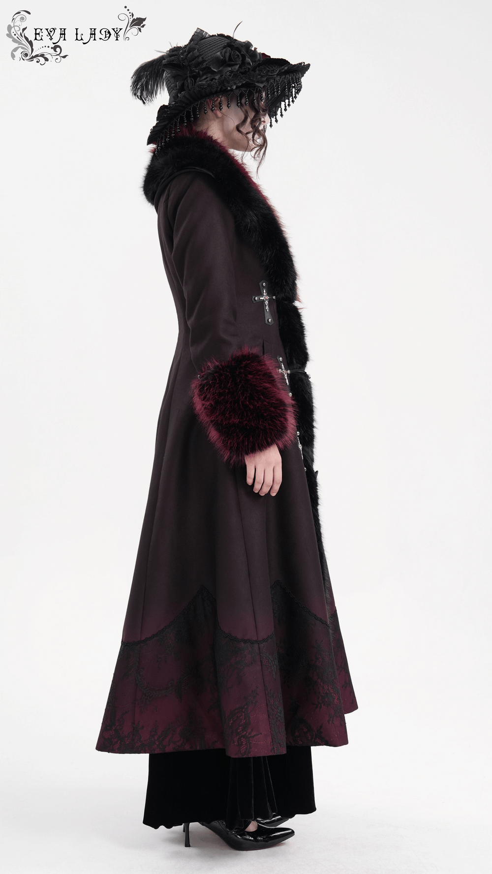 Gothic-inspired long coat with faux fur trim, cross buckles, and elegant silhouette for a stylish, dark winter wardrobe.