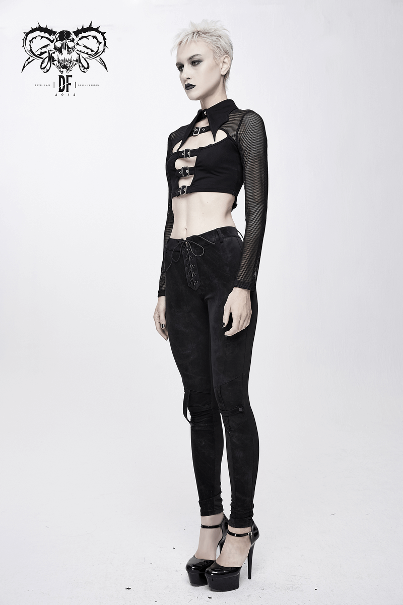 Stylish gothic woman wearing a black mesh crop top with buckle and collar, paired with sleek black leggings.