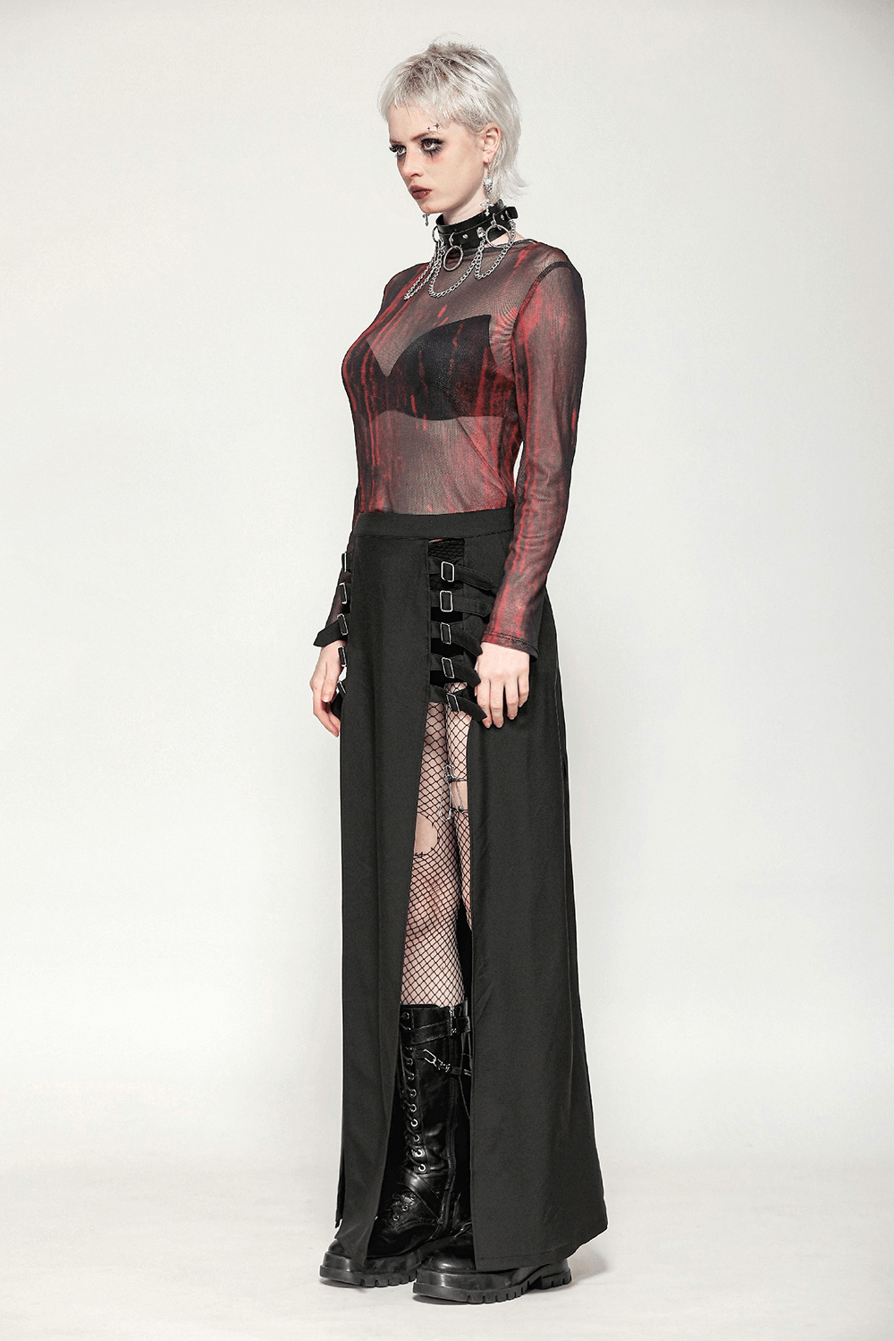 Edgy women's long sleeved sheer mesh top in red and black with stylish skirt and boots for a bold grunge look.