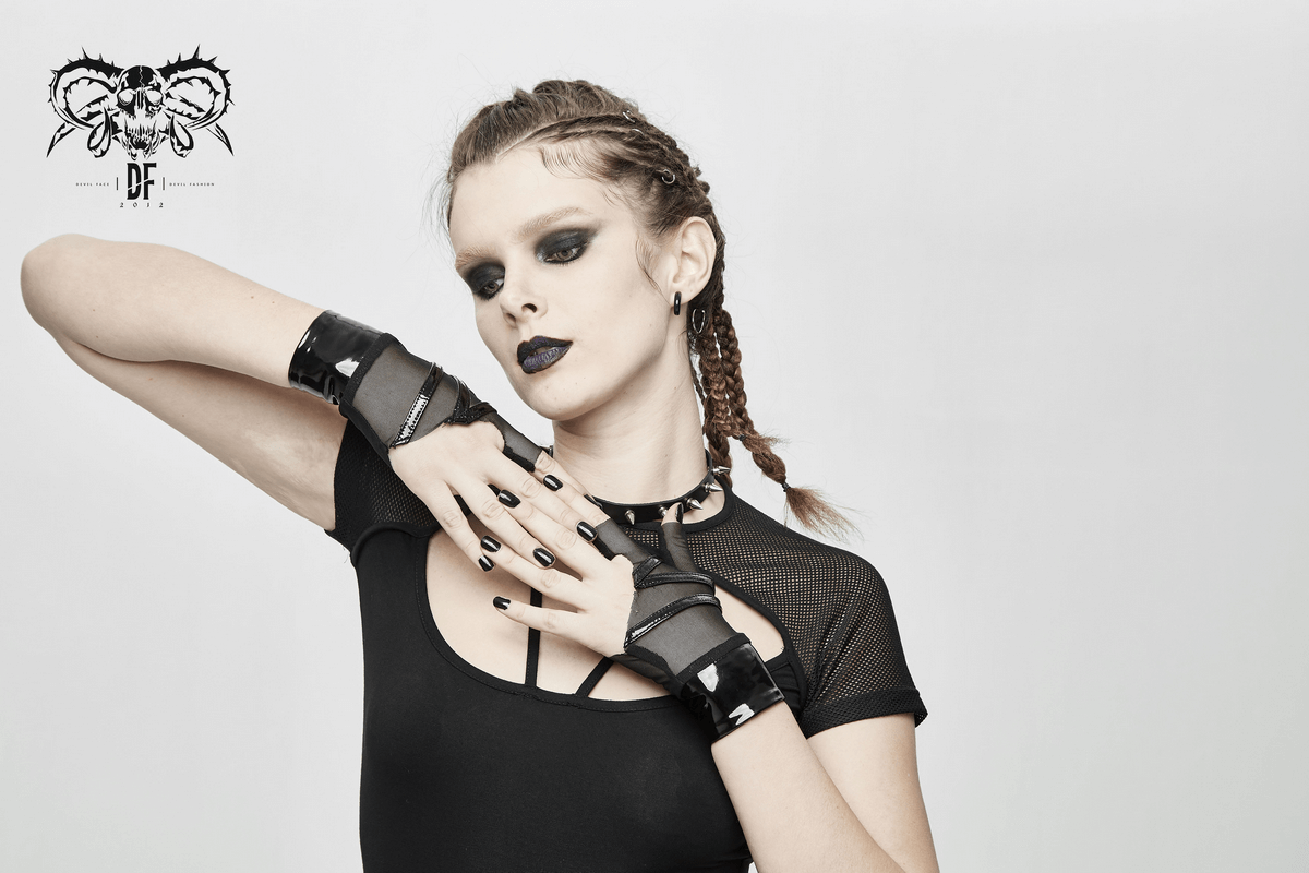 Trendy model showcasing black mesh fingerless gloves with wrist snap fastenings, embodying punk style elegance.