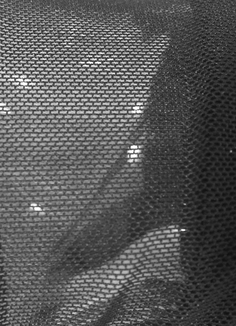 Close-up of black mesh fabric showcasing texture, ideal for trendy punk-style fingerless gloves.