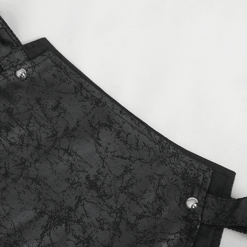 Close-up of the textured black fabric with silver buttons of a women's punk fishtail skirt.