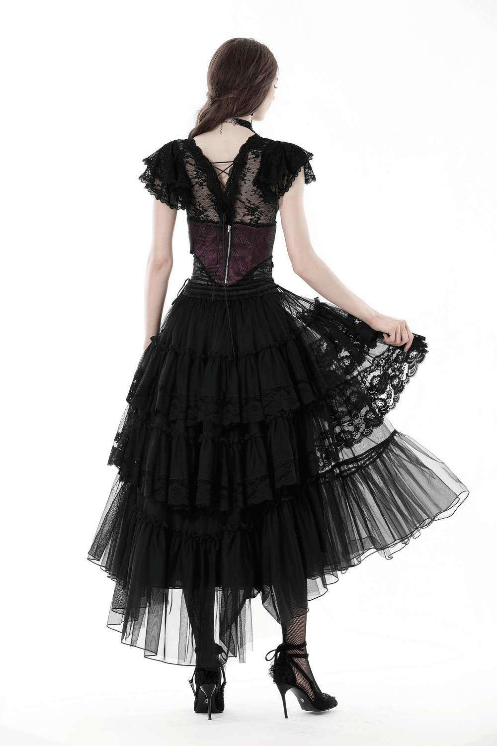 Back view of a woman's black mesh gothic skirt with lace and ruffles, perfect for an edgy outfit.