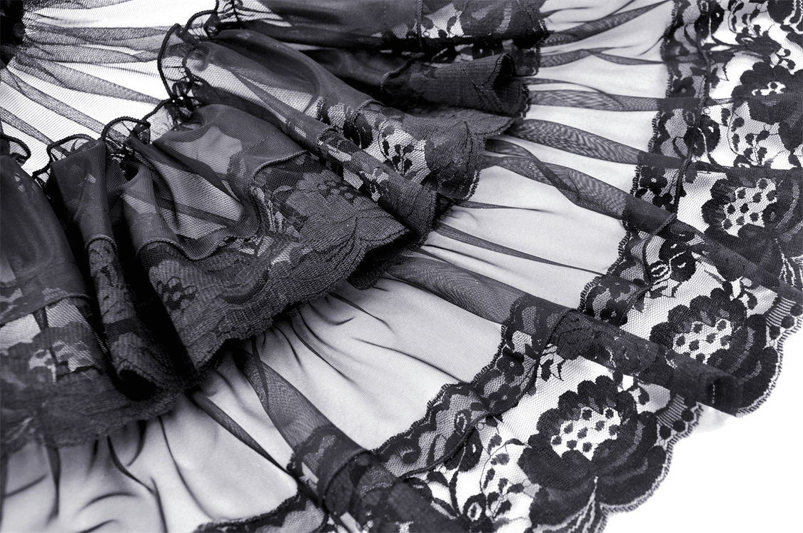 Close-up of black mesh fabric with lace trim and dramatic ruffles, perfect for a gothic skirt.