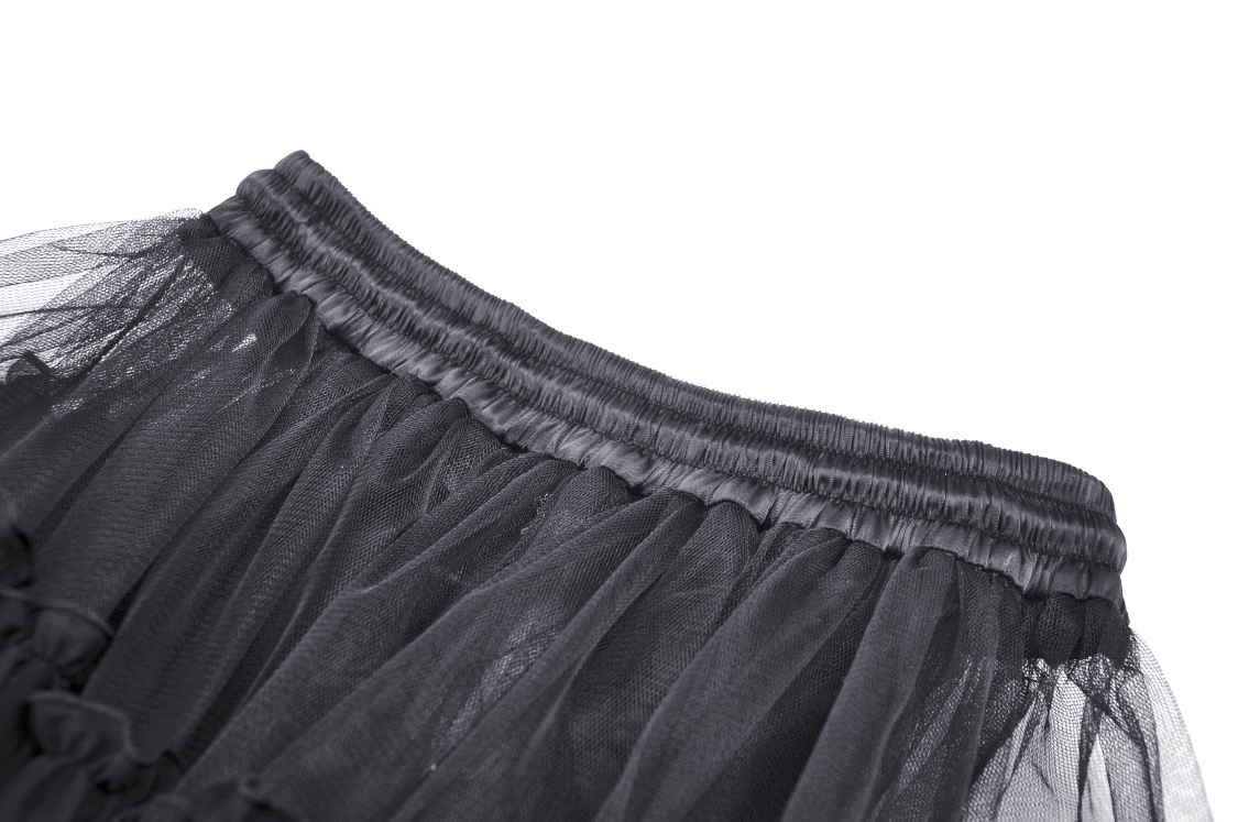 Close-up of the elastic waistband of a black mesh gothic high-low skirt with dramatic ruffles.