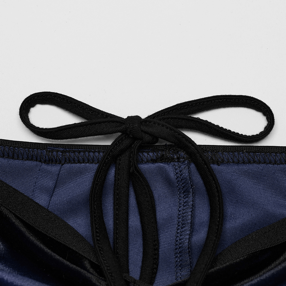 Close-up of navy velvet flared pants waistband with black tie detail, showcasing stylish design and quality craftsmanship.