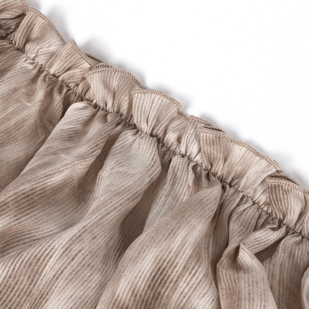 Close-up of textured fabric with ruffled edge in soft coffee color for women's off-shoulder top.