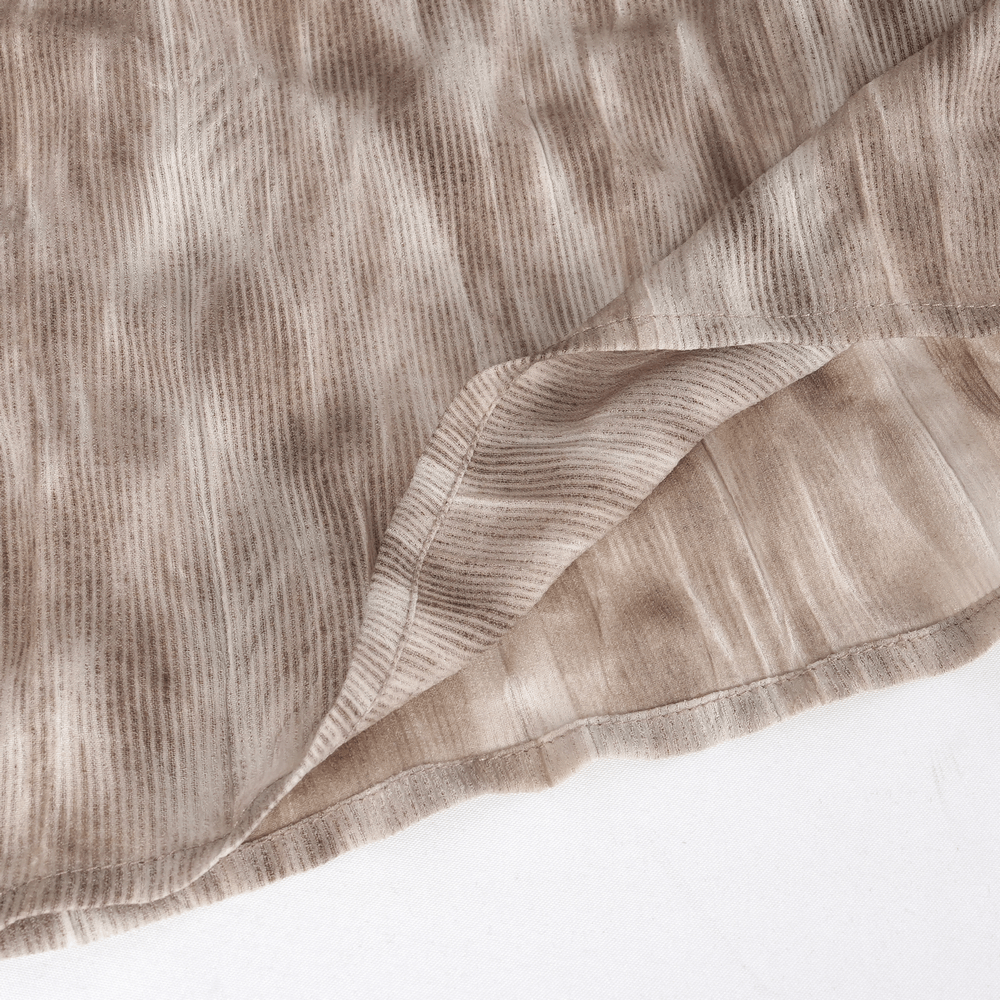 Close-up of textured lightweight fabric in coffee hue, showcasing intricate patterns and soft draping for women's top.