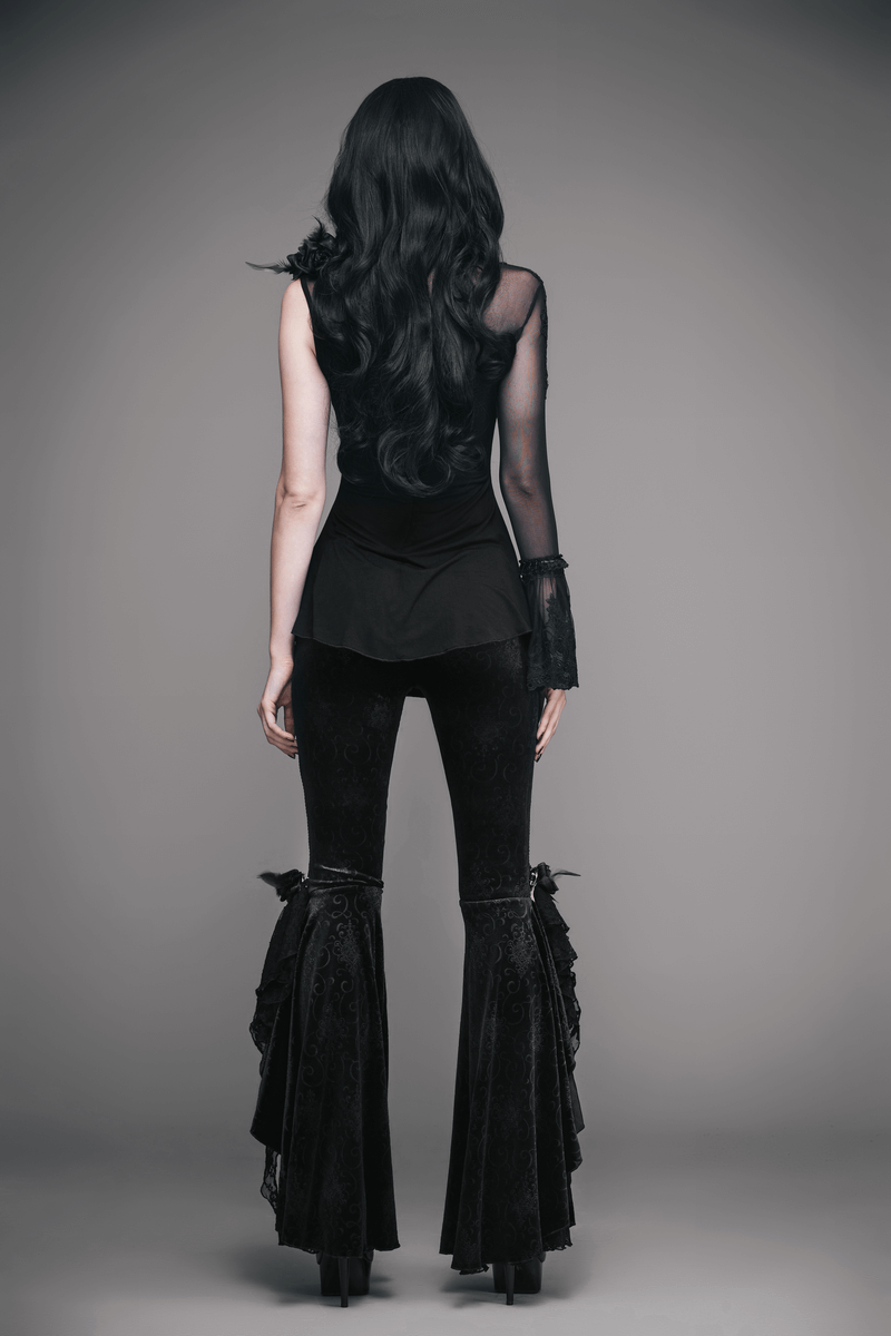 Back view of a woman in a gothic-style one sleeve asymmetric top paired with flared black pants.