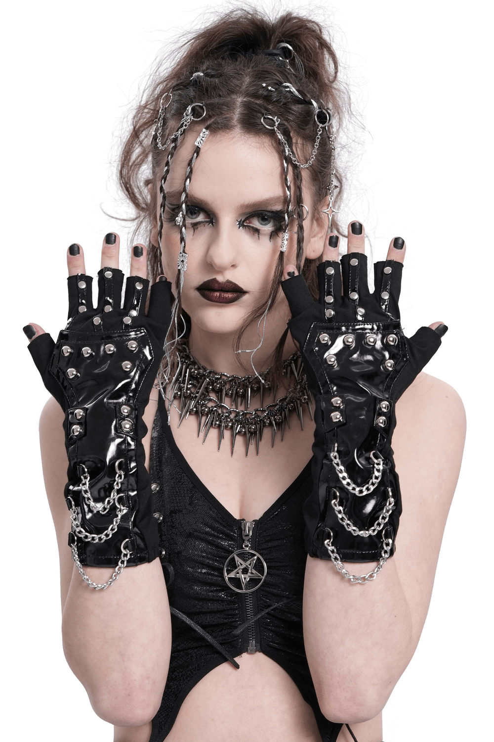 Edgy women's patent leather gloves with chains and studs, styled for a daring fashion statement.