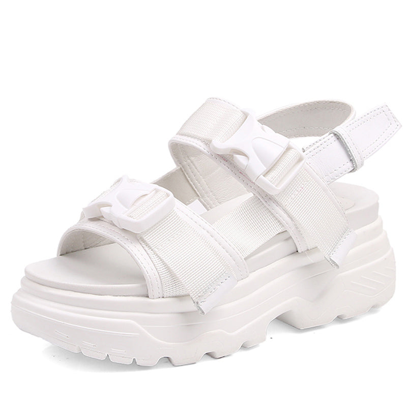 White women's platform sandals with adjustable straps and thick rubber sole, perfect for stylish beach outings.