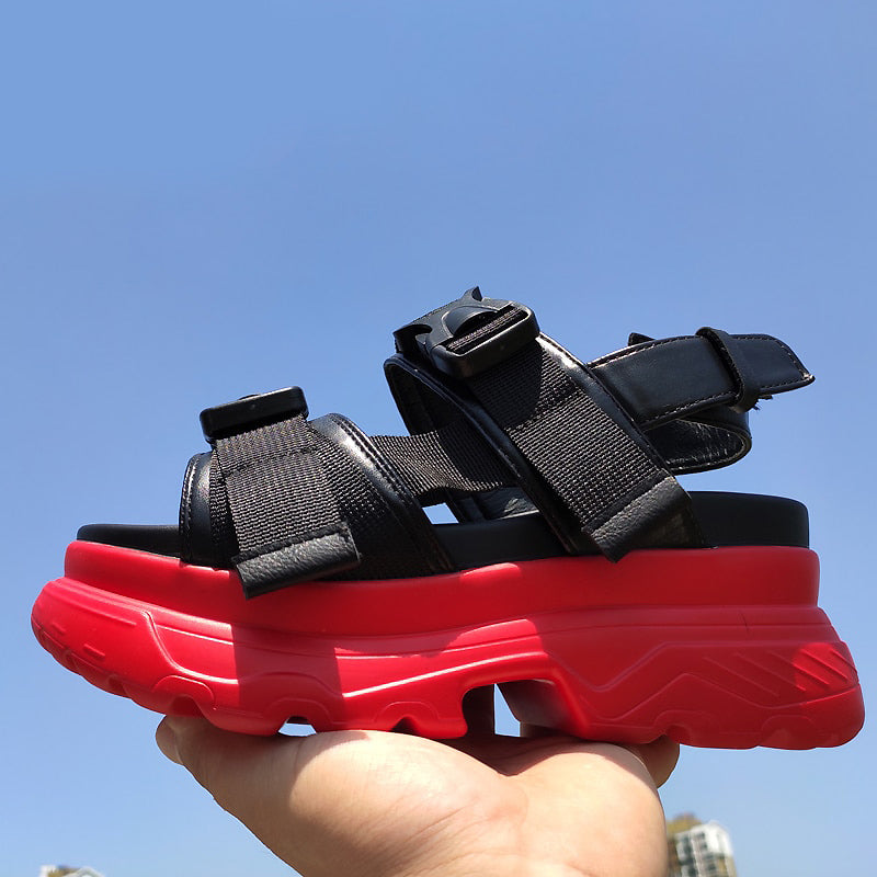 Stylish women's black platform sandals with red thick sole, adjustable straps, perfect for a chic goth look.