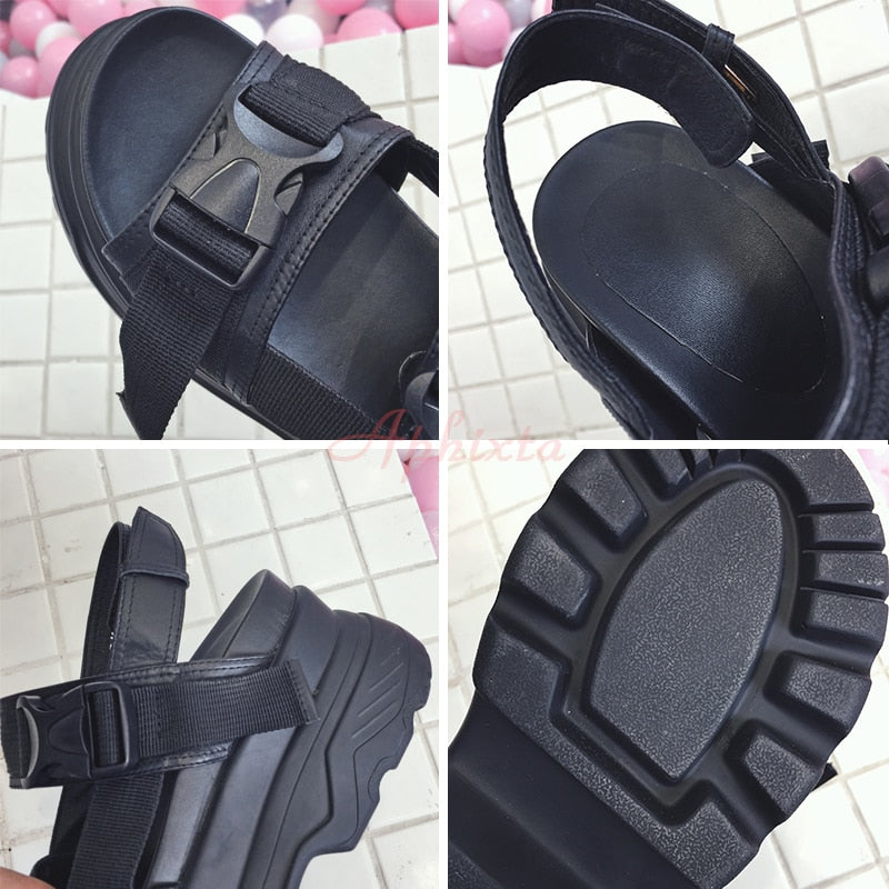 Women's goth style platform sandals with adjustable straps and thick rubber soles, perfect for a rock-inspired look.