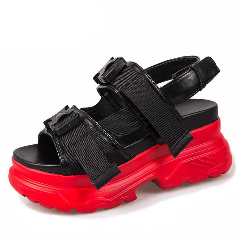 Stylish women's platform sandals with black faux leather straps and vibrant red thick soles for a bold goth look.