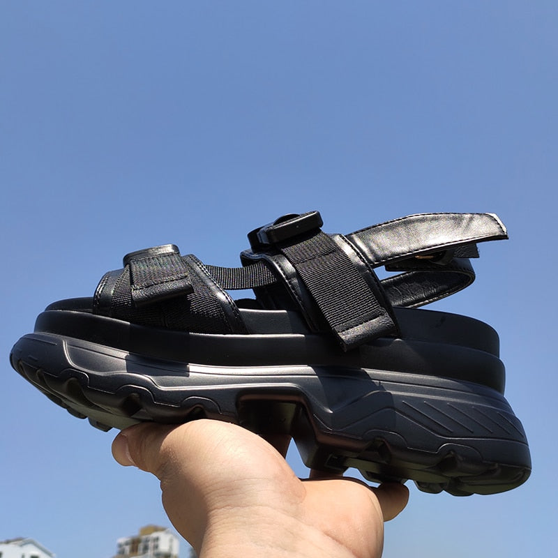 Stylish women's platform sandals with adjustable straps and thick rubber sole, perfect for a rock-inspired look.