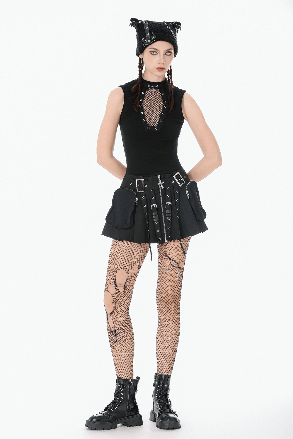 Women's Pleated Skirt with Zip Details and Studded Straps worn with edgy accessories and fishnet tights.