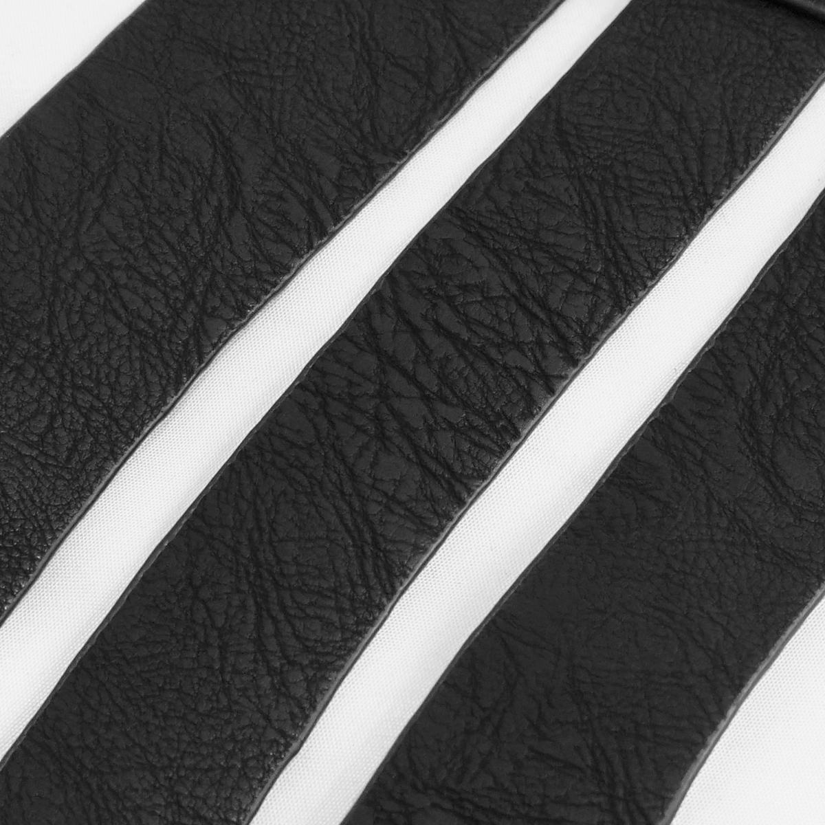 Close-up of textured black PU leather strips for gothic corsets or vintage belts, showcasing quality and style.