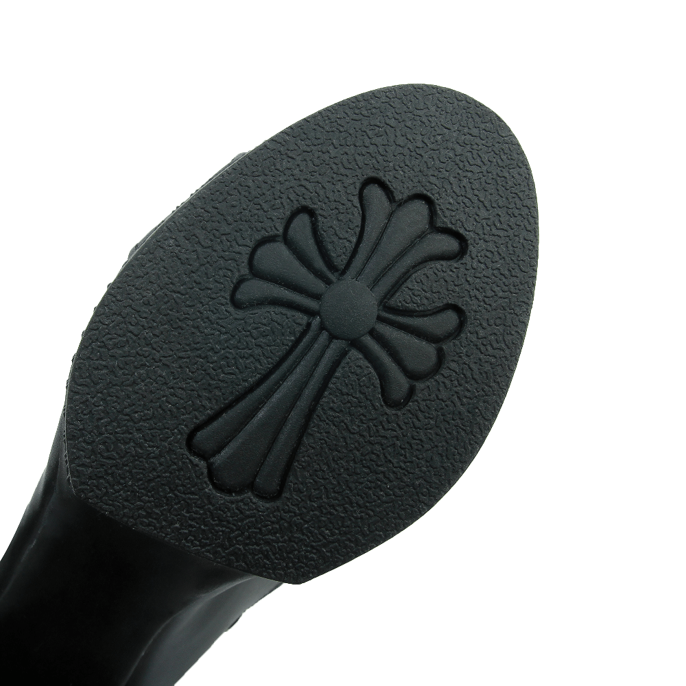 Close-up of the sole of a stylish knee-high gladiator sandal featuring a unique textured design.